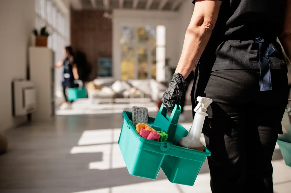 hiring a cleaning service in Sedona? Sedona Maid to Order Professional cleaner carrying cleaning supplies
