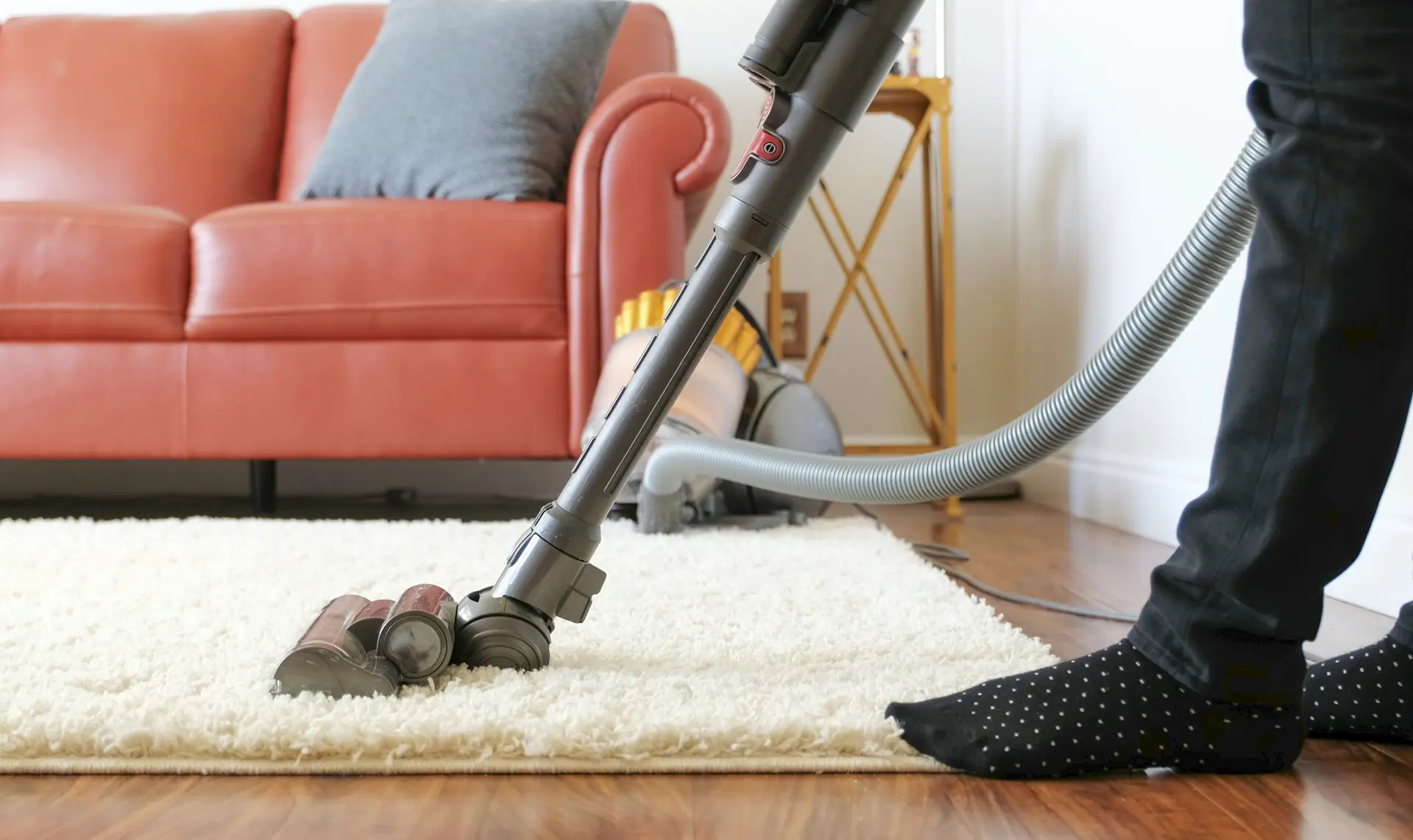 Professional cleaner vacuuming and deep cleaning carpets in a residential home in Sedona AZ
