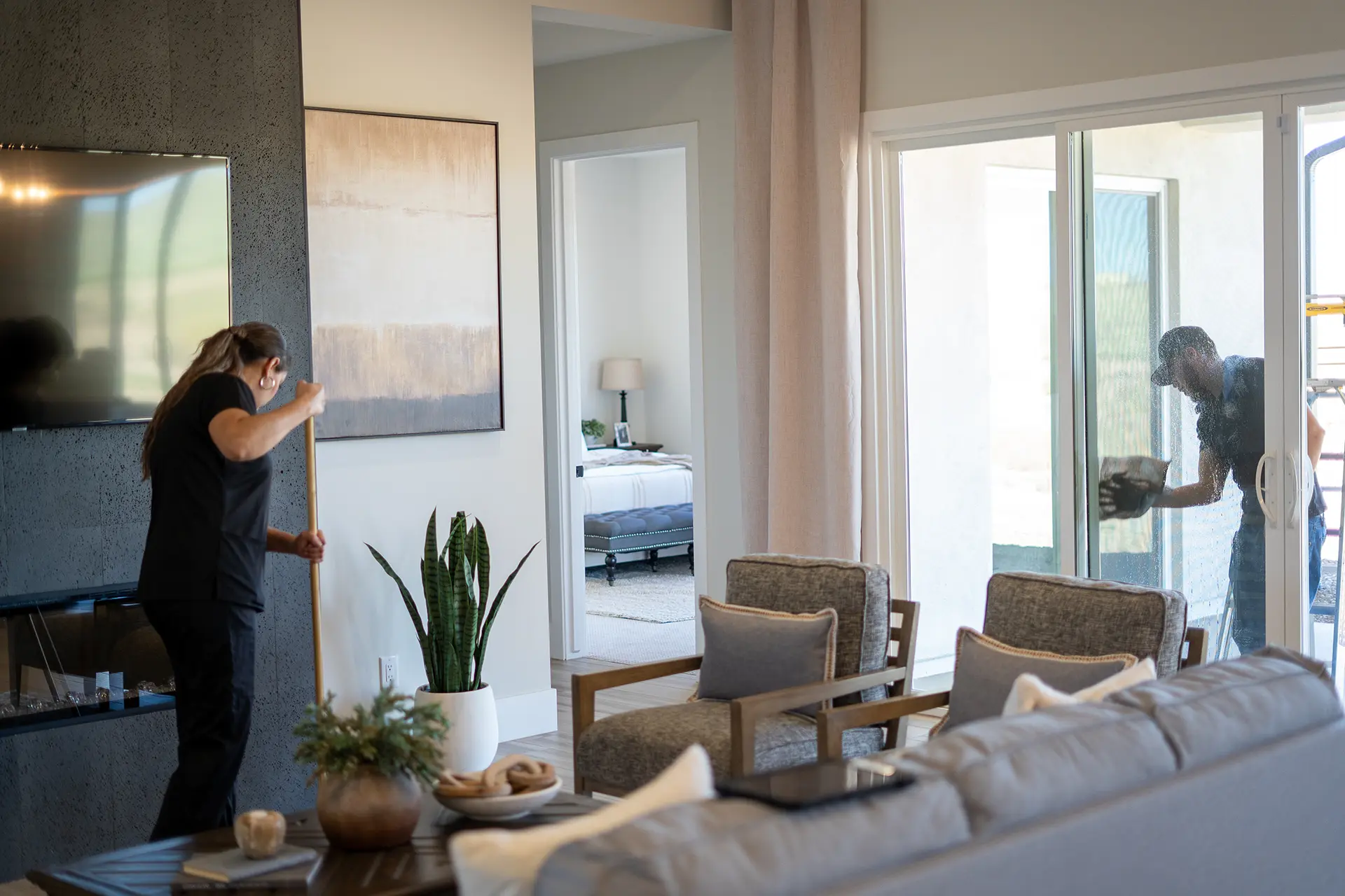Cleaning team mopping floors and washing windows together inside a spotless Sedona AZ residential home